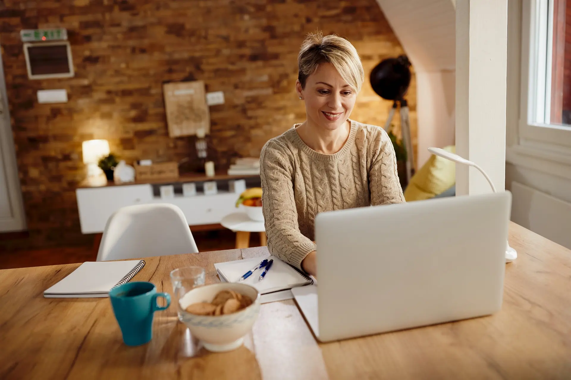 Remote support professionals collaborating through laptops and digital tools for executive and administrative client work.
