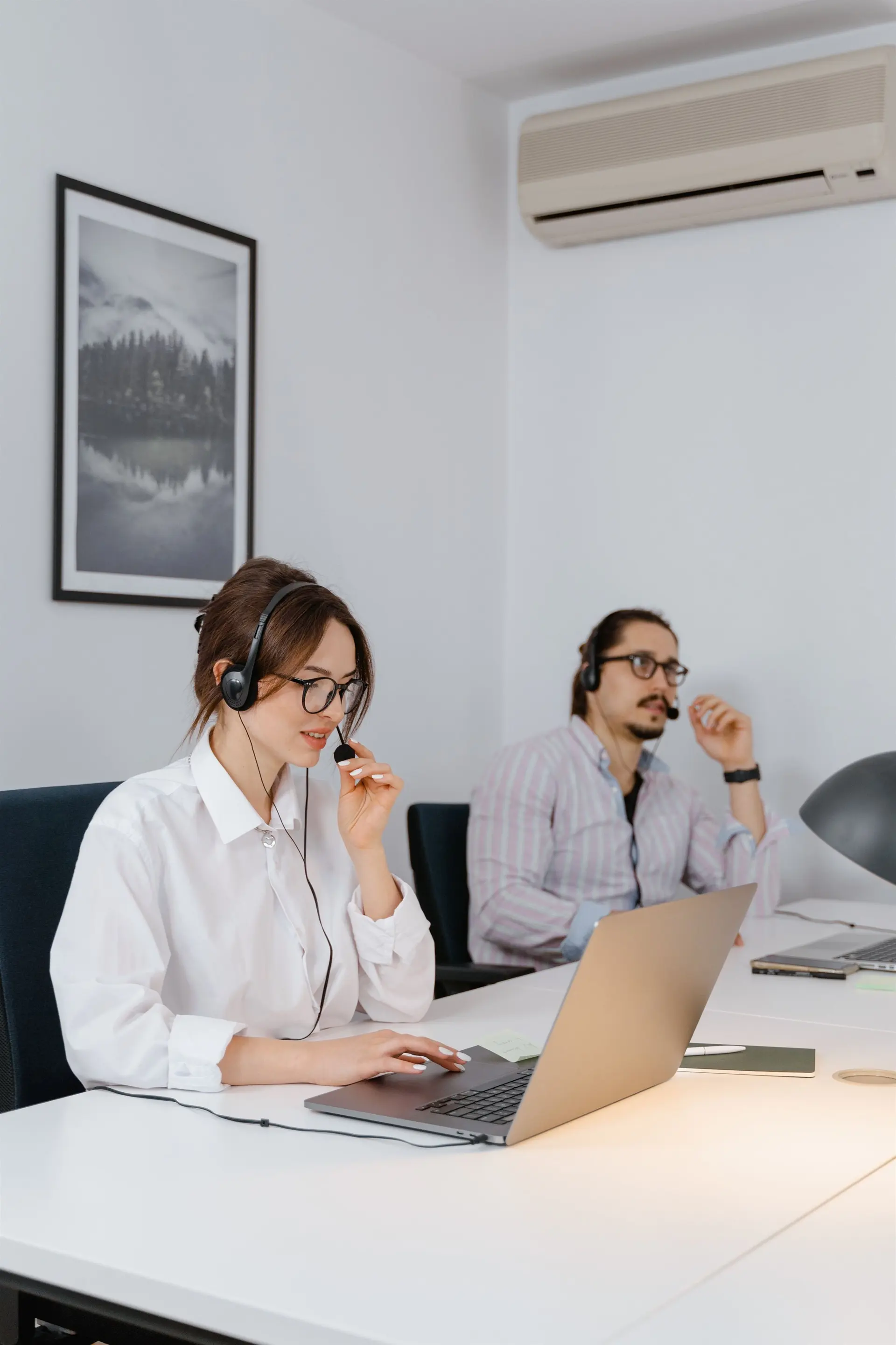 Virtual executive support professionals using headsets and laptops to coordinate schedules, communication and leadership priorities.