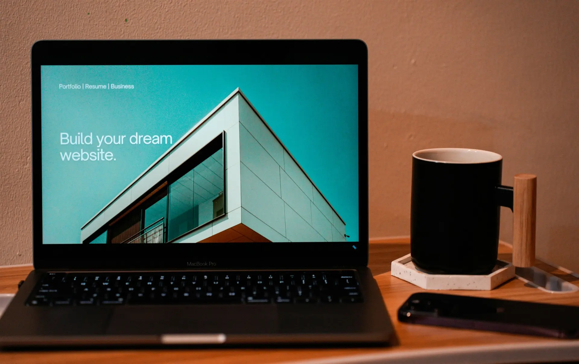 Laptop displaying a website design at a focused workspace for website updates, SEO structure and online content.